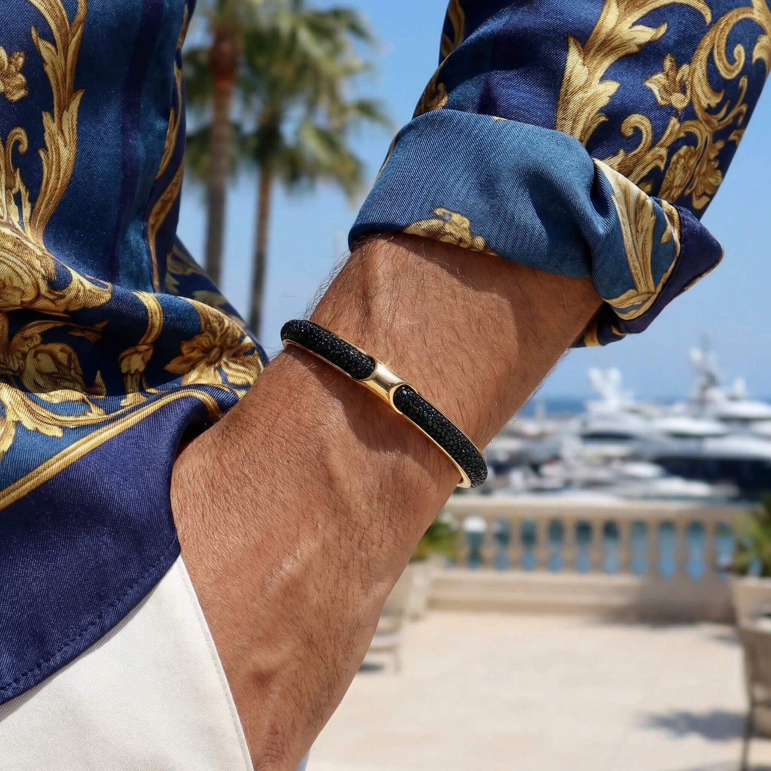 Woman wearing Infinity Black Stingray Golden cuff bracelet - unisex luxury
