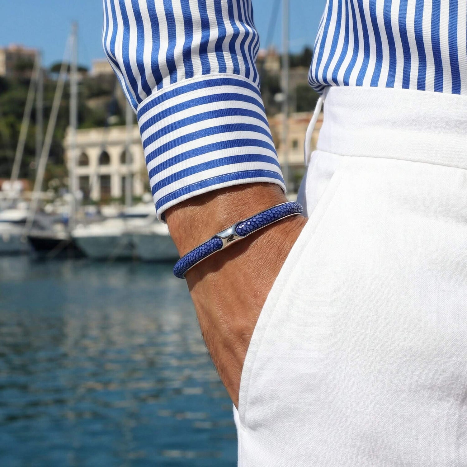 Infinity Blue Stingray cuff paired with steel watch on man's wrist
